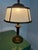 Elegant neoclassical bronze table lamp, circa 1930s, featuring its original vellum shade with beautifully aged patina and...
