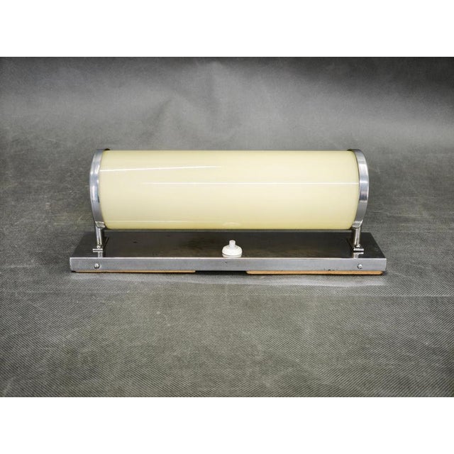 An elegant original bauhaus wall light produced in czechoslovakia during the 1930s. Featuring a refined chrome-plated...