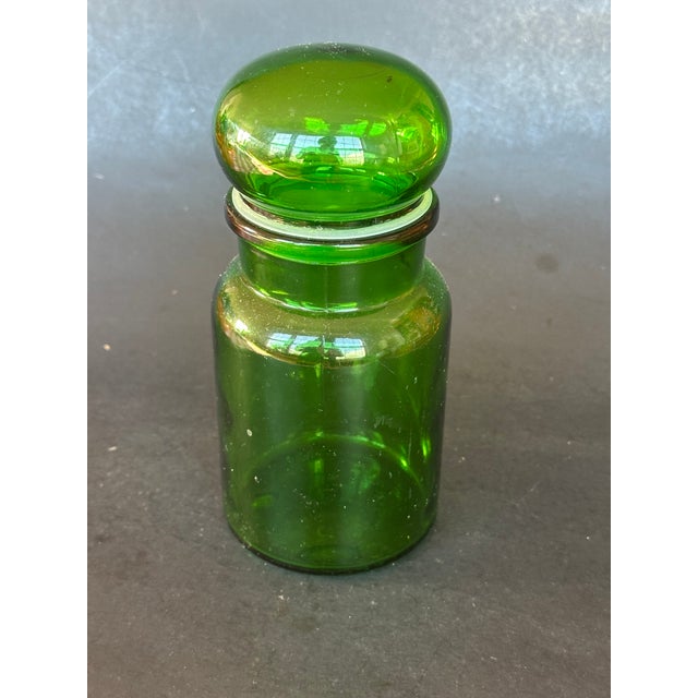 This vintage green glass apothecary jar will add a dramatic color pop to your home decor. Use the decorative glass bottle...