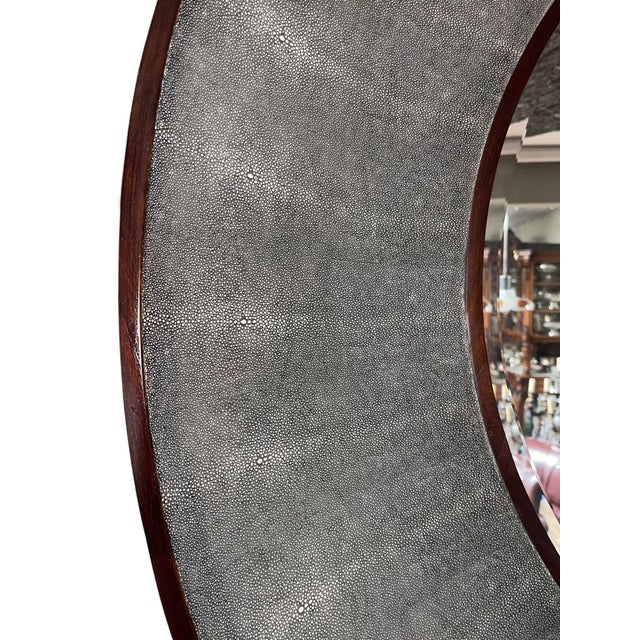 An elegant Italian round mirror featuring a dramatic deep concave frame wrapped in richly textured gray faux shagreen. The...