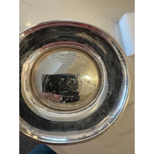 Elevate your collection with this timeless antique Tiffany & Co. oval bowl, crafted from genuine sterling silver and...