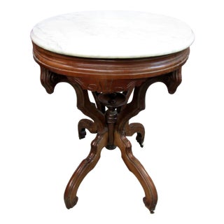 Antique Victorian Marble Top Parlor Table With Ornate Carved Wood Base & Wheels For Sale
