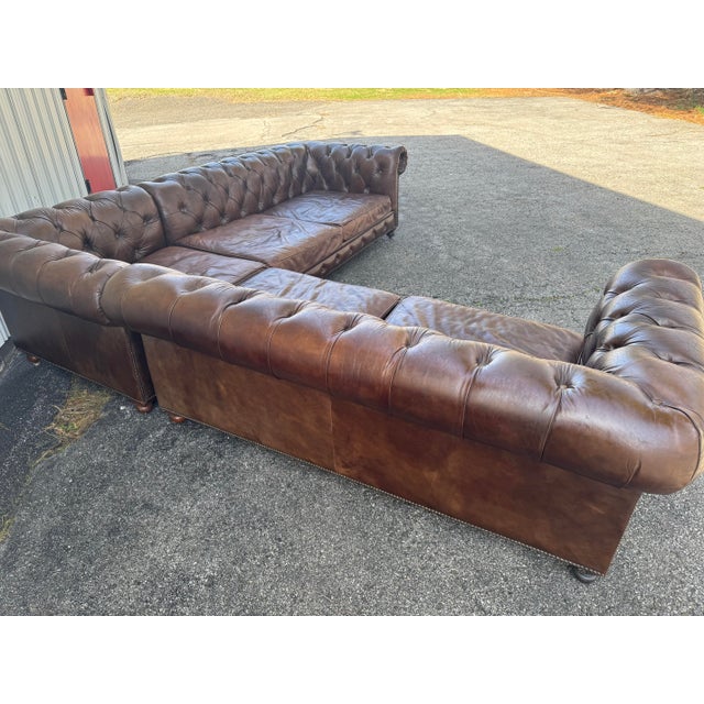 Restoration Hardware Leather Kensington Chesterfield Sectional in vintage cigar leather with down wrapped cushions. The...
