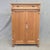 A charming and functional German natural pine tall storage cabinet with brass hardware and a working key. The clear...