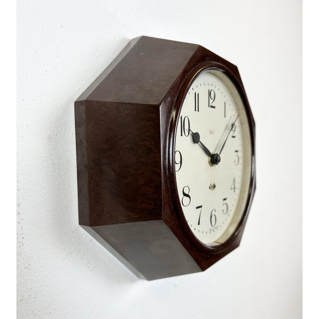 This wall clock was produced by Smith electric in England during the 1950s. It features a brown bakelite frame, an iron...