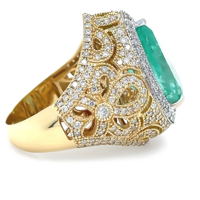 A Emerald & Diamond Dress ring, made of 18ct White & Yellow Gold. Set with a Pear, Mixed Cut Zambian Green Emerald...