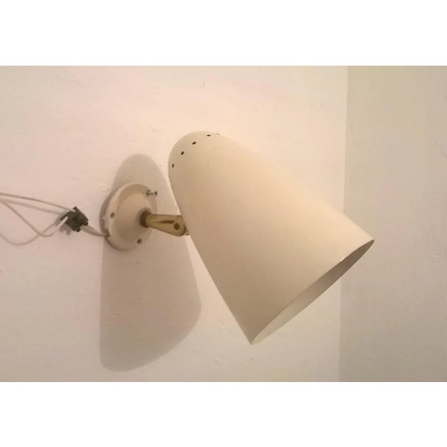 This large beige wall light was produced by Greco Illuminazione in Italy during the 1950s. The design is in the manner of...
