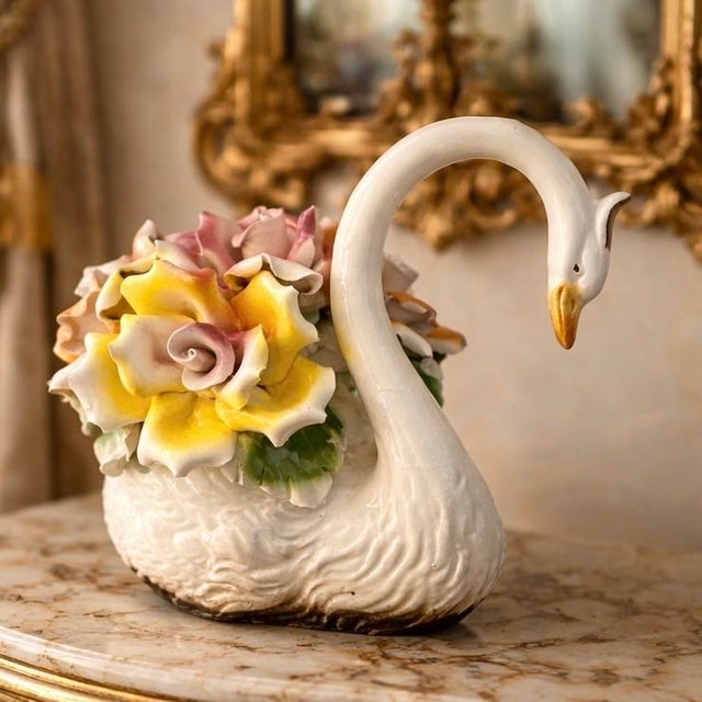 An elegant vintage Italian Capodimonte swan centerpiece, beautifully modeled with a graceful curved neck and finely...