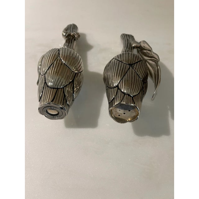 Quality silverplate salt and pepper shakers in the form of artichokes. The pepper mill holds peppercorns and can be opened...