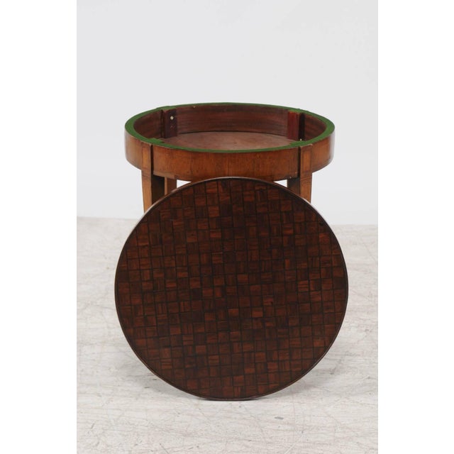 A French Louis XVI style round parquetry top game table with flip top and tapered legs from the second half of the 19th...