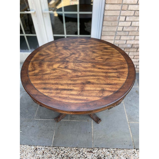 This is a remarkable vintage handcrafted Italian dining table.. The apron has four carved designs with scrolls. The top is...