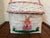 Charming Folk Art hand-painted white basket with pink trim. Features a girl bunny rabbit. Most items found at Pub & Oasis...