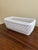 An elegant trompe l'oeil porcelain cachepot crafted in the form of a handwoven rope basket. Executed in glossy white...