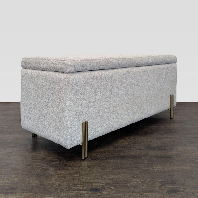 The bench has Plated iron legs in an Antique Brass finish. The seat lifts up via gas-lift mechanism to reveal storage...