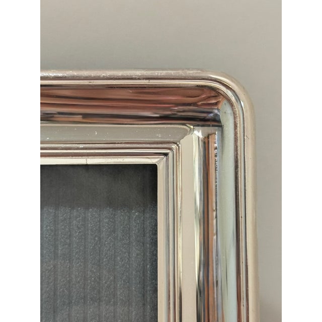 Refined sterling silver picture frame by Christofle, the renowned French silversmith celebrated for timeless design and...