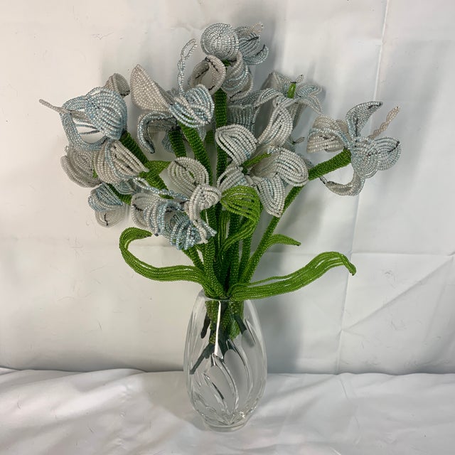 This is a delicate handcrafted French beaded flower bouquet featuring iridescent white and pale blue petals with vibrant...