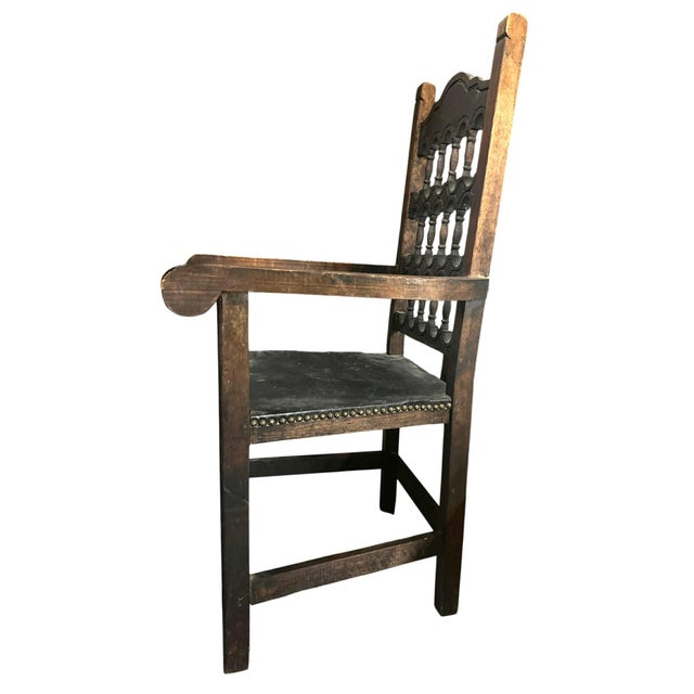 Handsome accent chair in dark stained pine and thick black leather. Vintage Spanish Colonial Rustic Style Mexican Pine and...