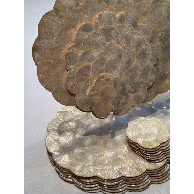 A rare find of 8 scalloped capiz and mother of pearl oval placemats with 8 matching coasters. All made in the Philippines...