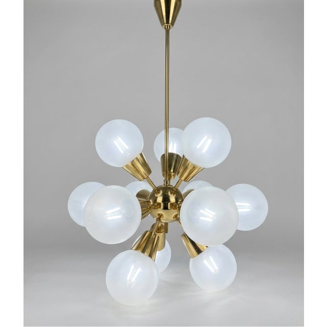 Mid-century Sputnik chandelier with a radial glass composition, designed to create a dynamic and evenly diffused light...