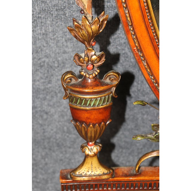 This exceptionally ornate English Adam-style wall mirror is a highly decorative example of the classical revival...