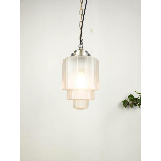 Beautiful early French art deco etched pendant light in a tiered skyscraper design. The gallery is made out of nickel...