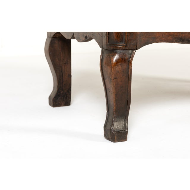A small 18th century french walnut commode with two drawers. the top is of double serpentine form, mirrored in the shaping...