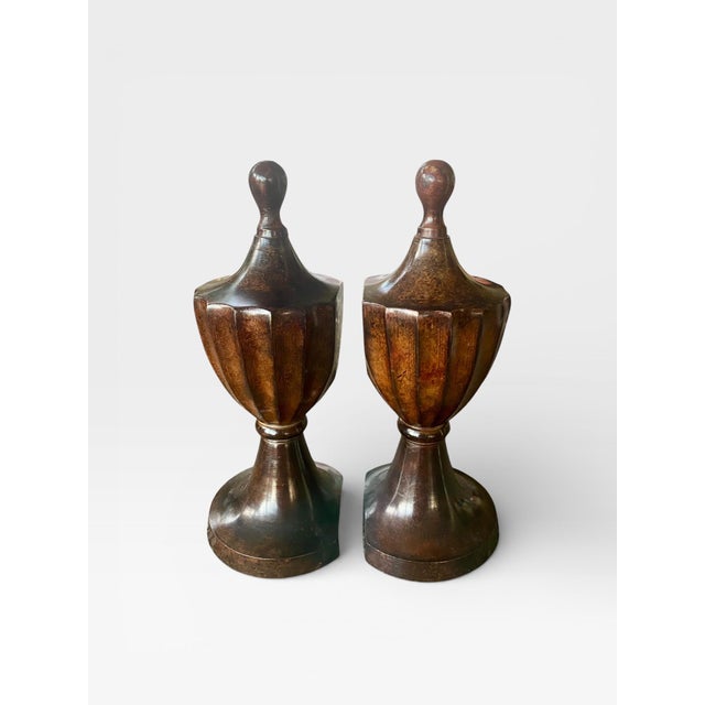 A refined pair of vintage turned wood urn-form finials featuring elegant faceted bodies, hand-turned finials, and a rich...