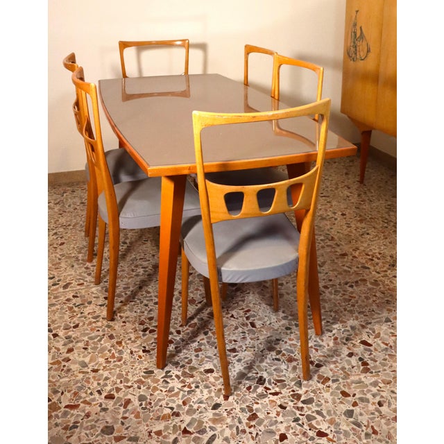 This beautiful dining set includes a maple and sycamore table with gray glass and six matching gray leather chairs. The...