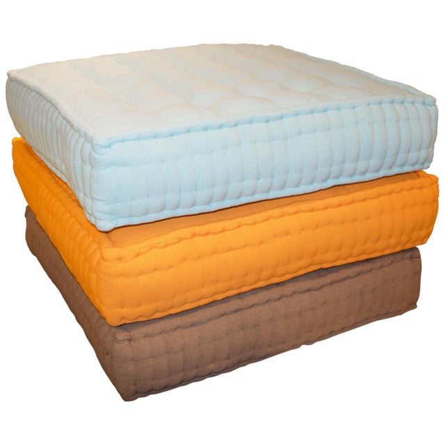 Cotton floor pillows. Available in tangerine and turquoise. The price reflects one.