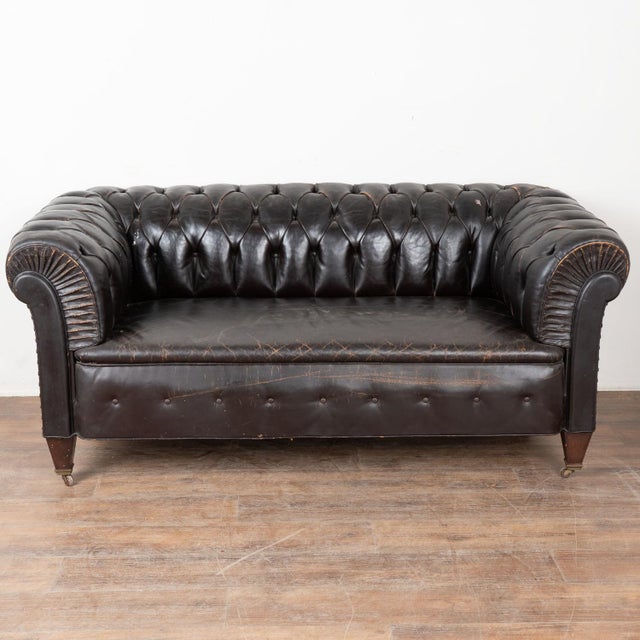 20th century leather Chesterfield 5.5' long bench seat sofa. Classic Chesterfield form with rolled arms, tufted button...