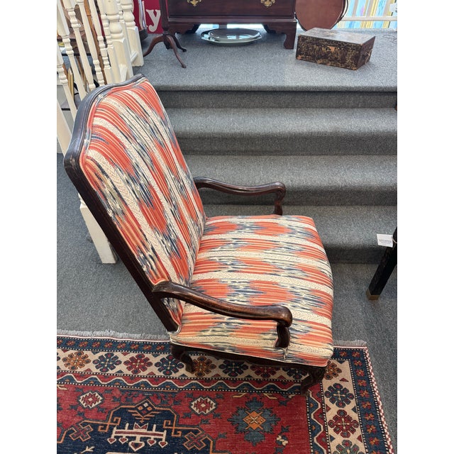 This is an antique French library chair. It has a hand carved frame. It has been newly reupholstered with a stunning...
