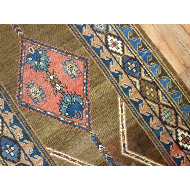 An early 20th-century Persian Serab runner with tribal and geometric elements. 3'6'' x 11'9''