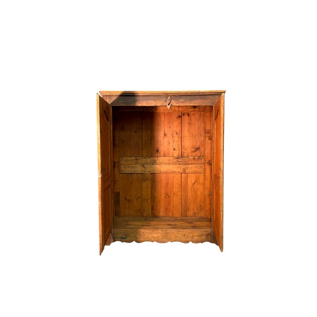 Antique 19th-century fir wood wardrobe featuring two finely crafted doors. Solid and well-proportioned, it features a...