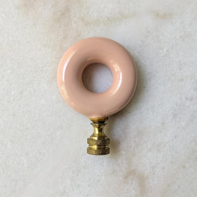 A colorful and unique vintage lampshade topper featuring an O-shaped glass finial with brass hardware. Dimensions: 3" H x 2"L