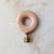 A colorful and unique vintage lampshade topper featuring an O-shaped glass finial with brass hardware. Dimensions: 3" H x 2"L