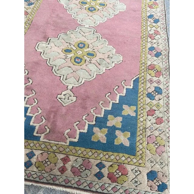Beautiful mid century Turkish rug with a geometric Kazak design and beautiful colors with pink, entirely hand knotted with...