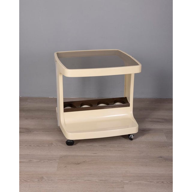 Bar trolley with white plastic structure and bottle holder, smoked glass top, designed by Marc Held for Prisunic, 1970s....