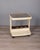 Bar trolley with white plastic structure and bottle holder, smoked glass top, designed by Marc Held for Prisunic, 1970s....