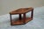 A stunning art deco side or center table in inlaid and mirrored burl veneer, carved edges and ebonized details. The table...