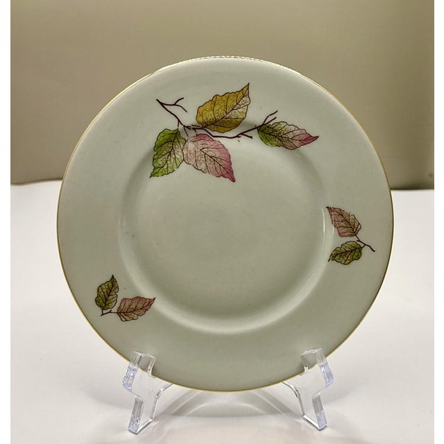 A set of eight vintage Bavarian Edelstein bread plates, each measuring 6⅜ inches and showcasing a delicate autumn‑leaf...