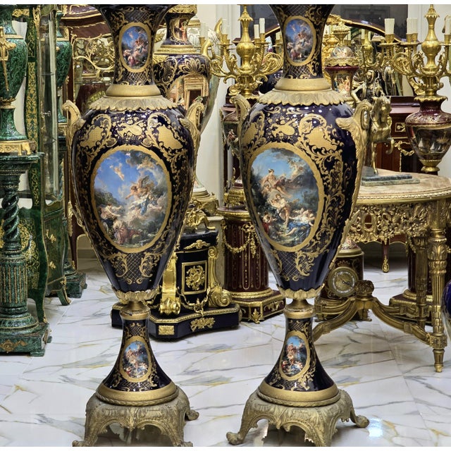 Elegant pair of French porcelain vases, decorated with a multicolored background and delicate galant scenes in reserve....