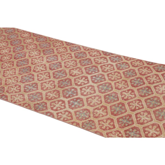 This vintage runner rug is a 3x8 Turkish distressed piece, made with hand-knotted wool circa mid-20th century. It is an...