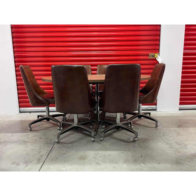 Mid Century Modern Chromecraft Dining Set with 6 brown swivel chairs on casters. Table has one leaf to extend the length....
