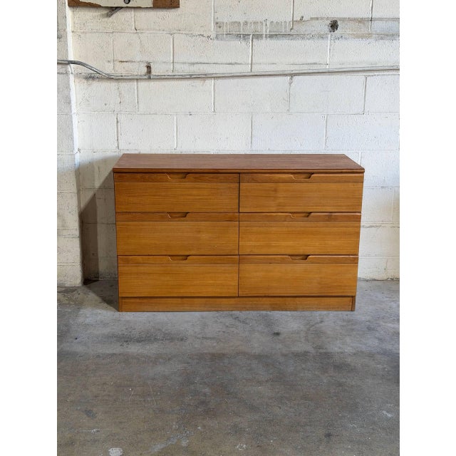 This six-drawer double dresser features a sleek profile on a solid plinth base. The streamlined form is accented by...