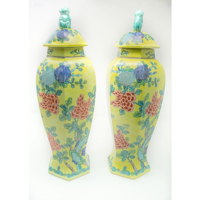 Pair of Chinese hand painted lidded urns. Striking yellow as the base color shows off the shape well. With turquoise,...