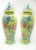 Pair of Chinese hand painted lidded urns. Striking yellow as the base color shows off the shape well. With turquoise,...