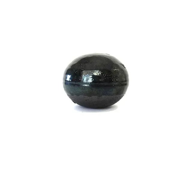 Black coil pottery ball rattle with black green glaze. Hand made. No cracks, no chipping. Glaze irregularities common to...