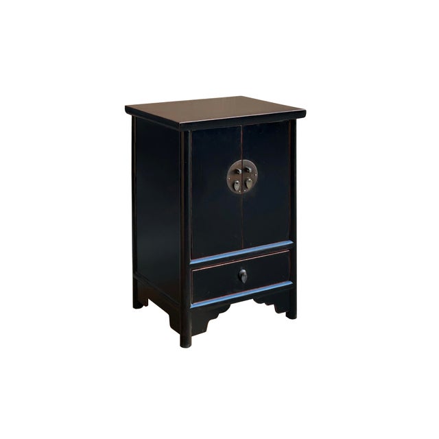 This striking Chinese-style accent cabinet is finished in a vibrant, weathered black that highlights the natural grain of...