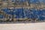 A hand-knotted wool rug, made in India and measuring 8' x 10'. Floral drawing carried across the field inside a...