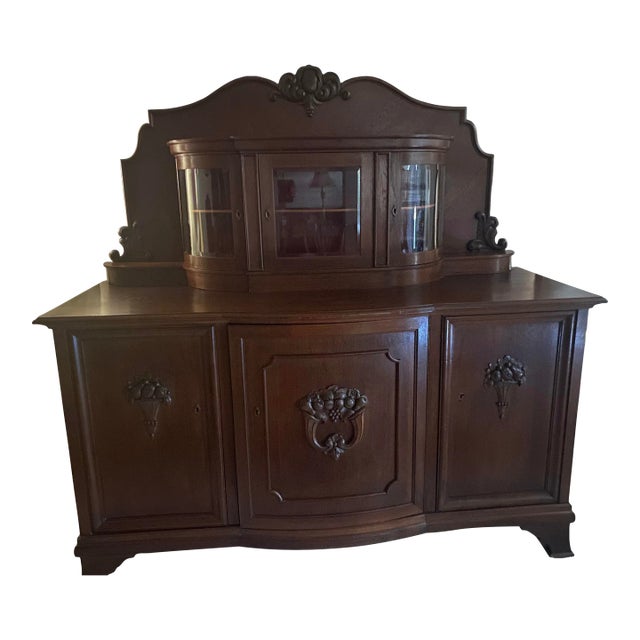An exquisite heirloom vintage Black Forest style carved oak Mid 20th Century European buffet. Outstanding historic...